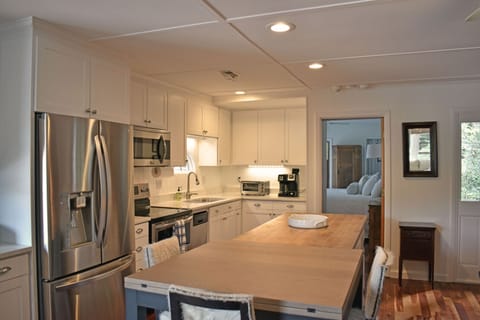 Fully stocked Kitchen is bright and functional with stainless steel appliance and lots of work-surface.