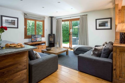 Cosy living room with wood burning stove and terrace doors