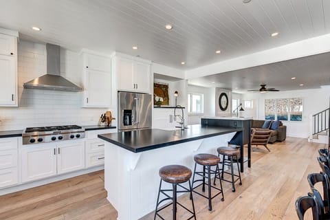 The second-level kitchen includes a spacious island with bar stools, making meal prep a social affair!