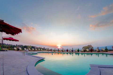 Seasonal outdoor pool, open 11:00 AM to 7:00 PM, pool umbrellas