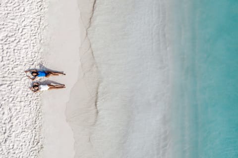 On the beach, white sand, sun loungers, beach umbrellas