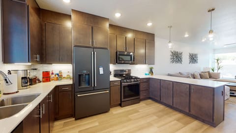 Spacious kitchen with upgraded fridge and full stocked kitchen and coffee bar.