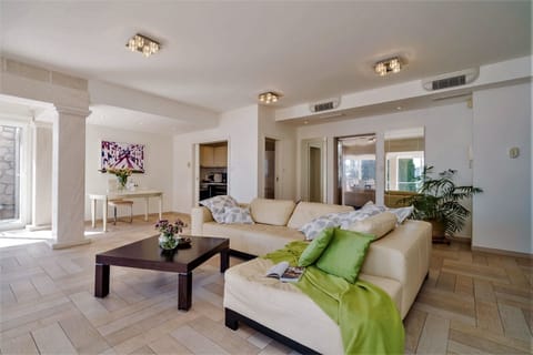 Living room with large comfortable sofa and working space of a luxury holiday villa with private pool and concierge service