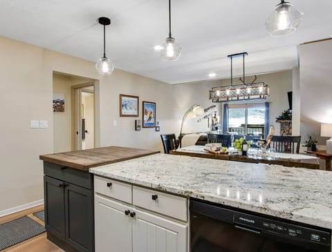 Entertain and Cook with Open Kitchen, Large Butcher Block, and Modern Lighting.
