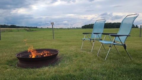 Can't you see yourself relaxing around the fire in a beautiful country setting? Complimentary firewood and chairs!