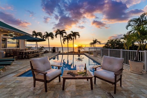 Sip your evening wine poolside as golden sunset paints the sky, creating the perfect backdrop for your tropical getaway.