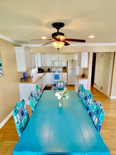 Large dining table with seating for eight adjacent to kitchen for the perfect family meal!