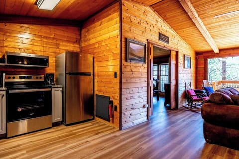 A warm, wooden cabin kitchen with modern appliances.