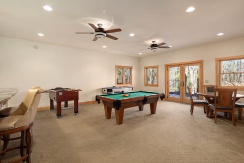 Everyone can play games at the same time.  Glass doors lead to the lower level patio.