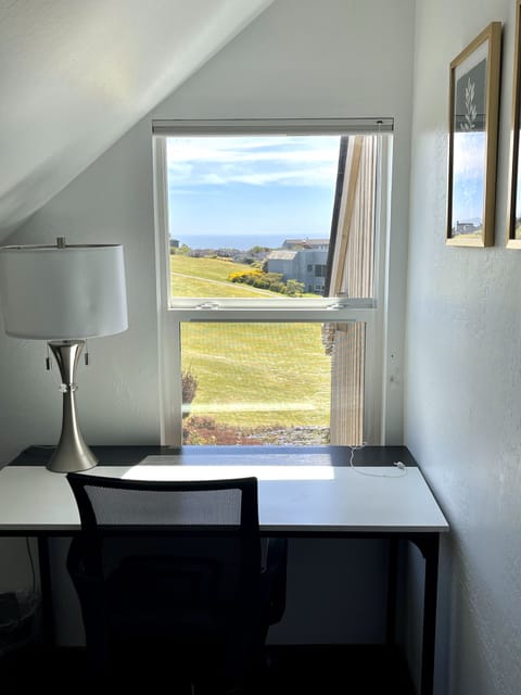 A working area with desk and chair on loft.