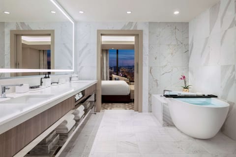 Suite, 1 Bedroom (Strip View) | Bathroom | Rainfall showerhead, designer toiletries, hair dryer, bathrobes