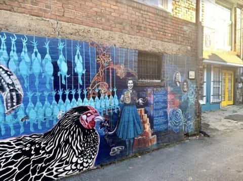 Chicken Alley mural adjacent to front door of apartment