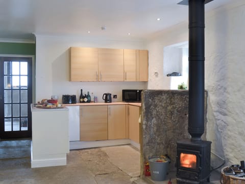 Delightful kitchen with original flooring and architectural details | The Calving Shed, Near Neilston