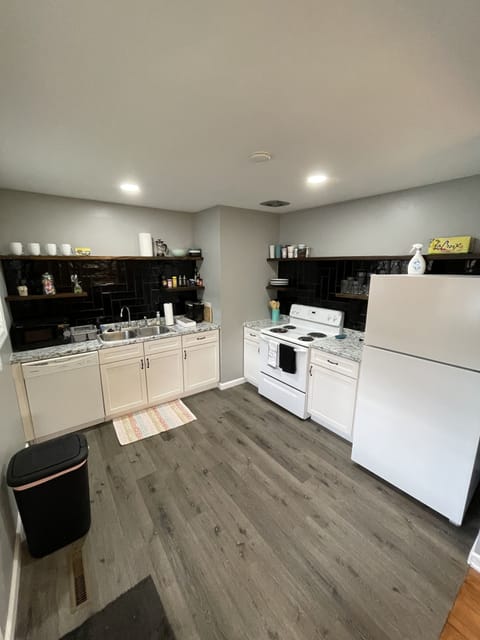 Modern kitchen with dishwasher, oven, microwave, and Refrigerator. 