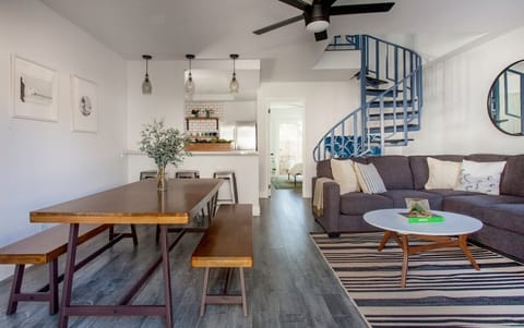 Living Area with Dining Room and Spiral Staircase to two Bedrooms Upstairs