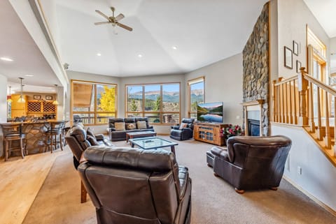 Living Room: 2 couches, 3 chairs, gas fireplace, Roku TV, floor-to-ceiling windows