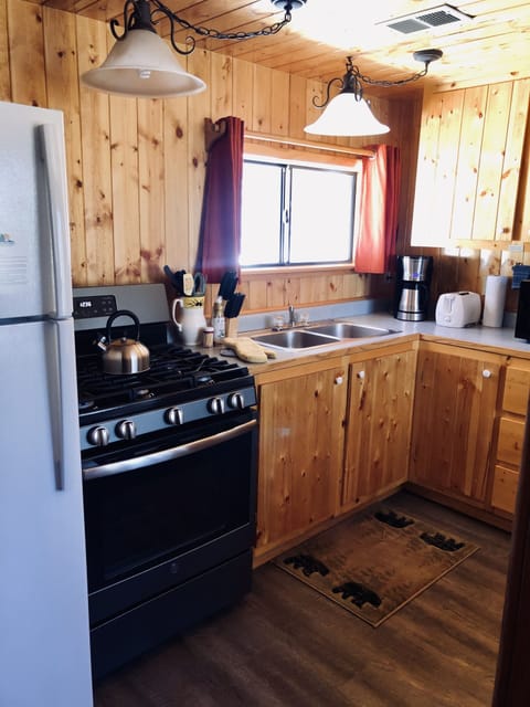 The kitchen offers a full-size refrigerator/freezer and a gas range.