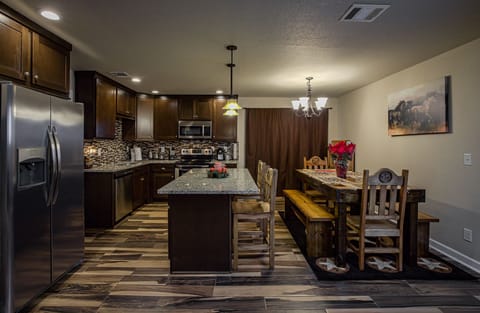 Fully furnished kitchen.  Island seating, dining table with bench seating. 