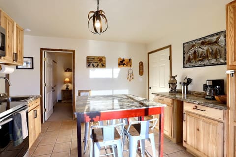 - Dining area with a mountain style table and seating for six beneath cozy lighting
- Wall art and a dreamcatcher add local flavor to this inviting corner
- Easy access to the hallway leads to bedrooms and bathroom areas with ease

