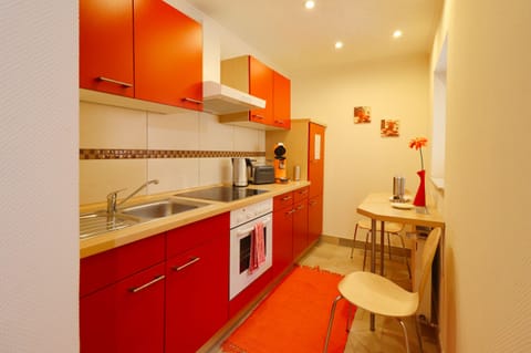 Comfort Apartment, Patio | Private kitchen | Fridge, coffee/tea maker, highchair