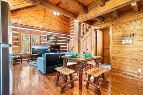 Dining & living room, stairs to the loft bedroom, and the bathroom door on the right.