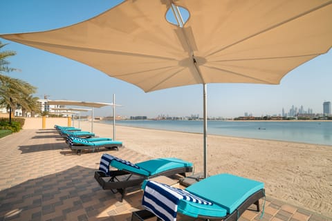 Private beach, white sand, sun loungers, beach umbrellas