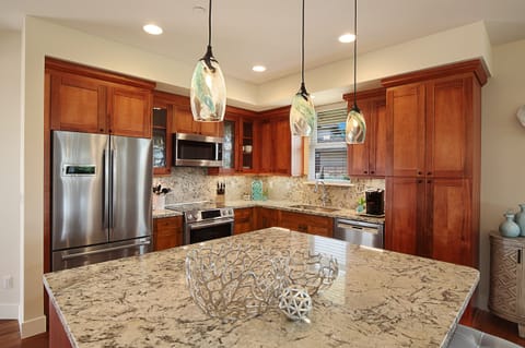 Chef-worthy kitchen with stainless steel appliances, granite countertops, and a spacious breakfast bar for casual mornings or gourmet nights in.