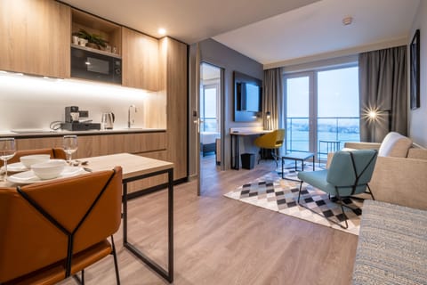 Suite, 1 Bedroom | Living area | 32-inch flat-screen TV with satellite channels, TV