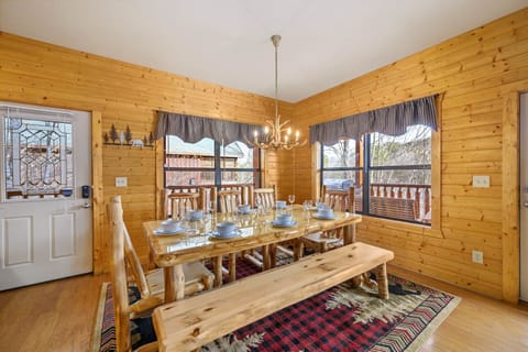 Custom hand carved log wood table with antler chandelier! Cabin details all over