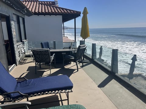 Upper deck w/ two lounges, table, two umbrellas
