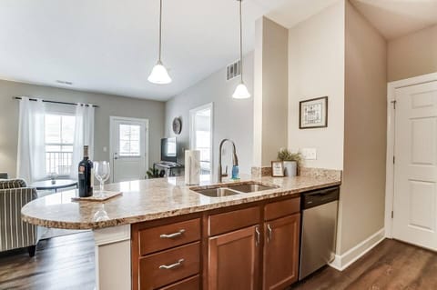 The kitchen features stainless steel appliances and lots of space on the granite countertops!