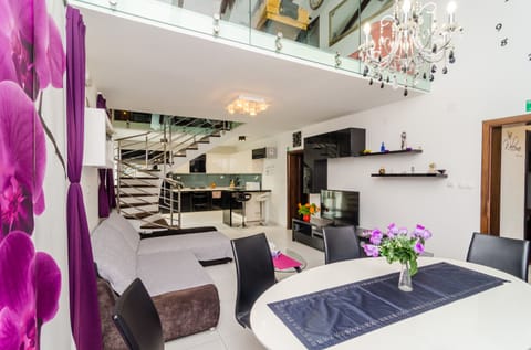 Apartment (Four Bedroom Duplex Apartment) | Living room | 25-inch flat-screen TV with cable channels, TV, DVD player