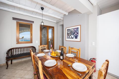 Open-plan living room with sofas, dining area, kitchen, WiFi internet, and satellite TV