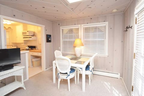 A small yet functional dining area with seating for three, ideal for cozy gatherings and quick bites