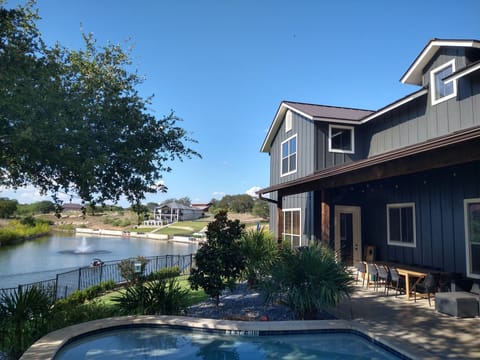 Back yard view of pool, covered patio and cove