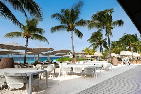 On the beach, white sand, sun loungers, beach towels