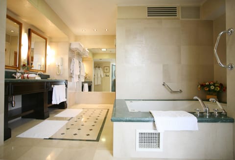 Suite, 1 King Bed, Non Smoking | Bathroom | Shower, free toiletries, hair dryer, towels