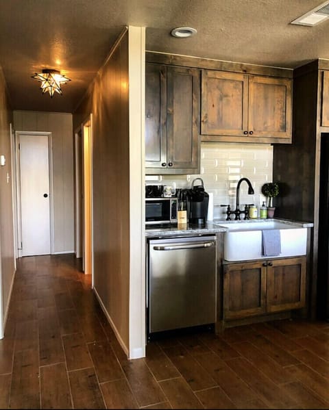 Full kitchen and long hall way that leads to the bedrooms.