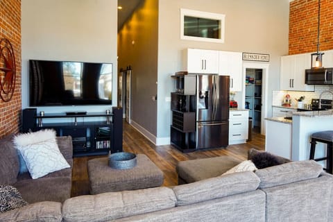 Looking from common area west towards the 1/2 bath, bedroom, laundry room and entrance door.