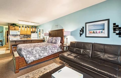 The living room houses a queen bed and sleeper sofa for extra sleeping space