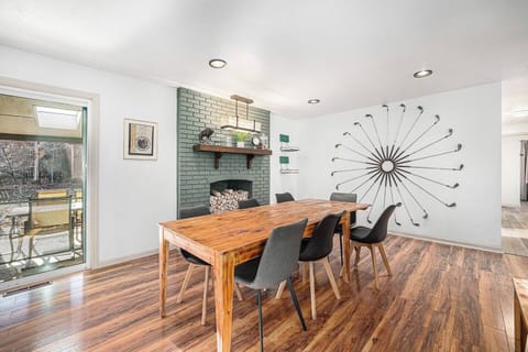 - Dine in style with a reclaimed wood table and striking golf themed wall feature
- Faux brick fireplace nook and modern lighting set a warm, creative atmosphere
- Patio access brings fresh air and outdoor charm right to your mealtime moments