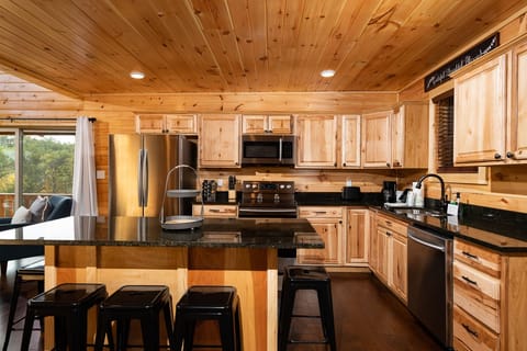 Cabin 2: up bar with 8 stools at, open to dining room and kitchen