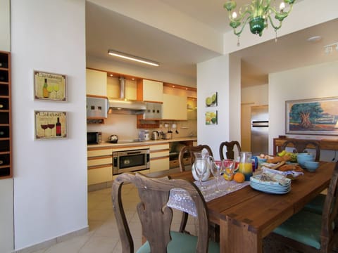 Villa | Private kitchen | Stovetop, highchair, dining tables