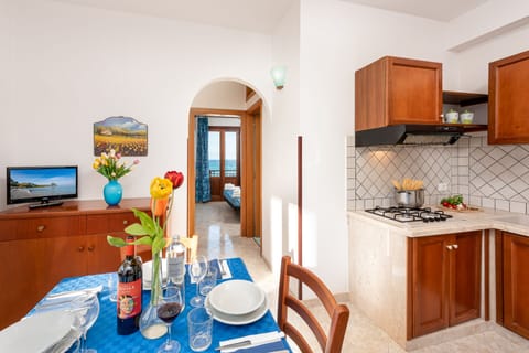 Standard Apartment | Private kitchen | Fridge, stovetop, electric kettle, cookware/dishes/utensils