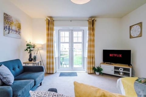 Open plan living room benefiting from a large double sofa bed and Smart TV.