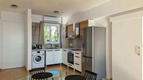 Luxury Apartment | Private kitchen | Fridge, electric kettle, highchair, cookware/dishes/utensils