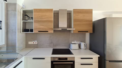 Luxury Apartment | Private kitchen | Fridge, electric kettle, highchair, cookware/dishes/utensils