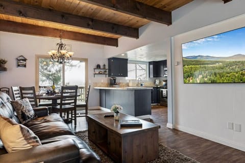 Open Living Concept with an adjustable amazing large Smart TV 65 inches, all new kitchen, exposed wood beams and comfy leather seating with a wood burning fireplace and views for days on one of two amazing decks.