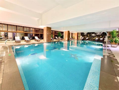 Indoor pool, pool umbrellas, sun loungers