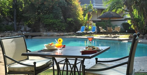 Outdoor pool, open 6:00 AM to 6:00 PM, pool umbrellas, sun loungers